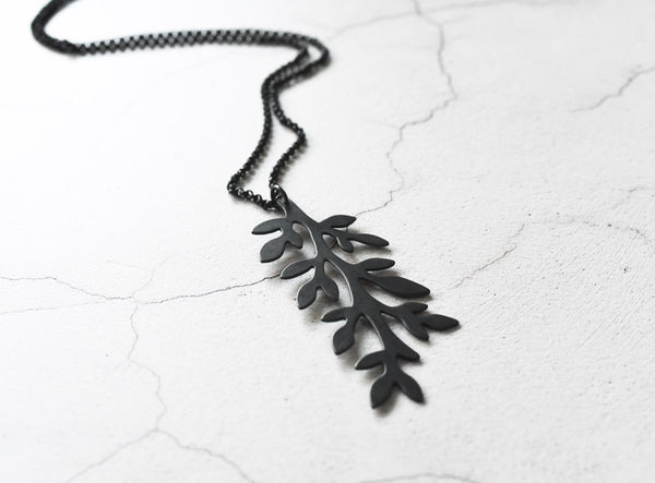 angle view of black leaves sterling silver necklace