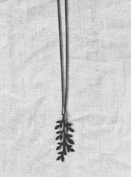 front view of black leaves sterling silver pendant