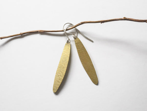 view of hand made textured simple leaf earrings, made of brass with sterling ear wires